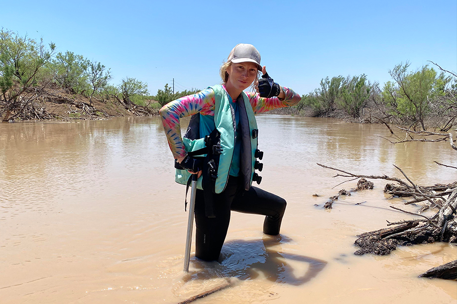 Laramie Brook Mahan checking the status of turtle traps in the Pecos River after a flash flood in Texas in 2021.