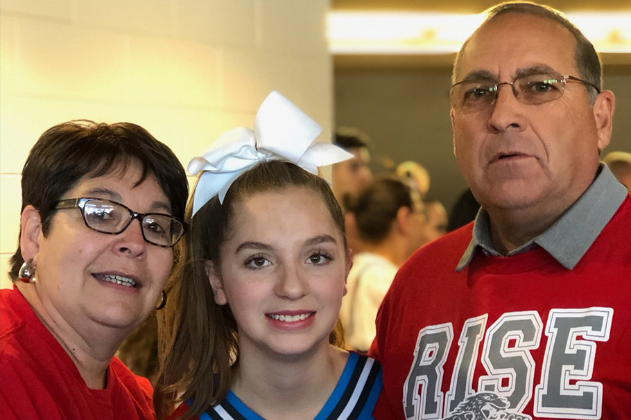 Lawrence "Larry" Chavez with his wife, Rose, and their granddaughter Lauren at the NMAA 2019 State Spirit Championships when Valencia High School won the Class 4A State Championship.