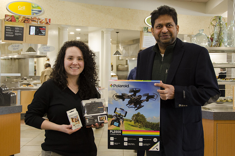 Hannah Spearman, unit marketing coordinator for Sodexo at ENMU, with Dr. Ajay Singh and his Polaroid prize package.