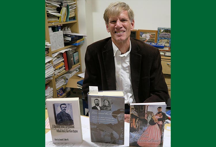 Dr. Donald Elder III with three books he has written.