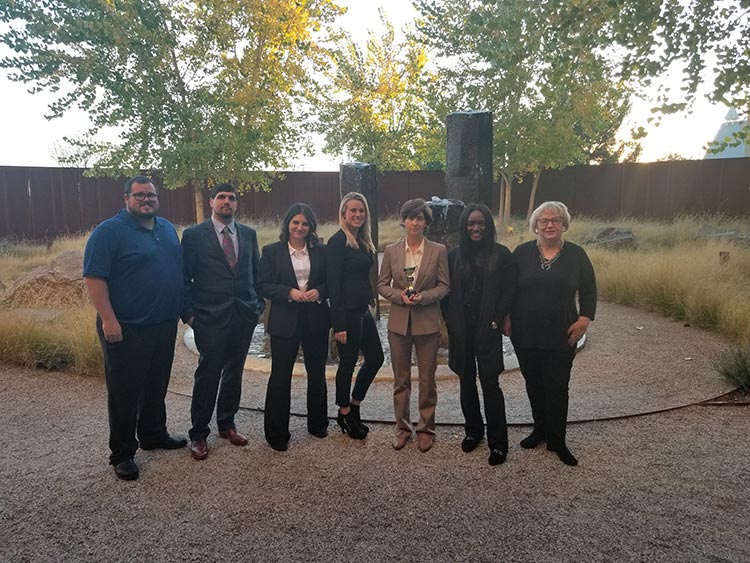 students with professors at ethics competition outside