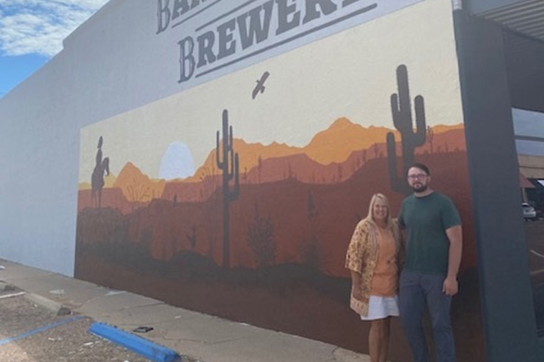 Gina Gossett Davis and James T. "J.T." Berry by the mural they created.