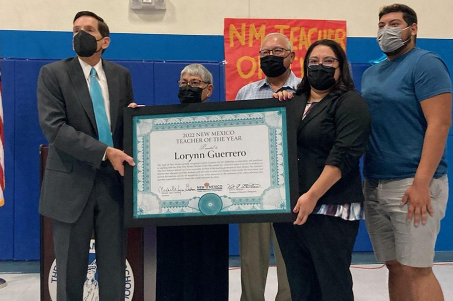 Lorynn Guerrero with her family while receiving her award from the New Mexico Secretary of State Kurt Steinhaus, who is also a Greyhound Grad.