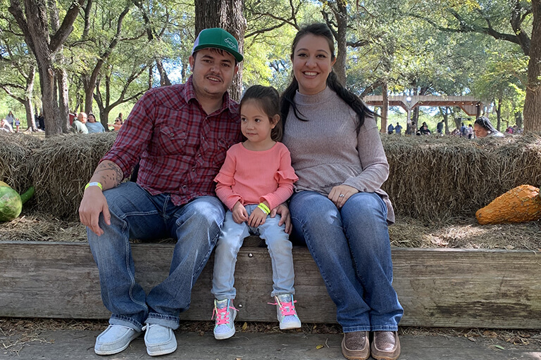 Lourdes and her family enjoying the warm weather in Fort Worth, Texas, at a pumpkin patch.