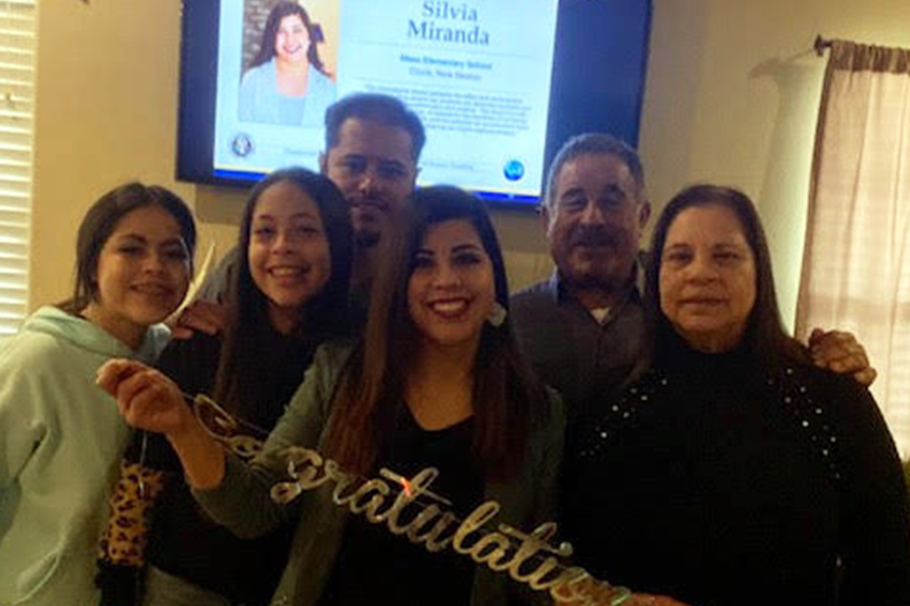 Silvia Miranda watching the virtual Presidential Award for Excellence in Mathematics and Science Teaching (PAEMST) ceremony with her husband, daughters and parents.