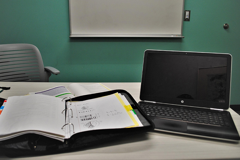 Computer and notebook in a study room