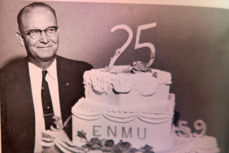 Dr. Floyd Golden with a cake celebrating the 25th anniversary of ENMU opening. 