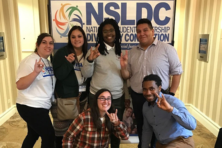 ENMU students showing the National Student Leadership Diversity Convention (NSLDC) leaders how to do the Greyhound hand sign. (Top Row, L-R): ENMU students Kaitlyn Bigham and Annabel Jauregui and NSLDC coordinators Ayannah Johnson and Jose Luis Posos. (Bottom row, L-R): ENMU student Anna George and NSLDC Director Dr. Christopher C. Irving.