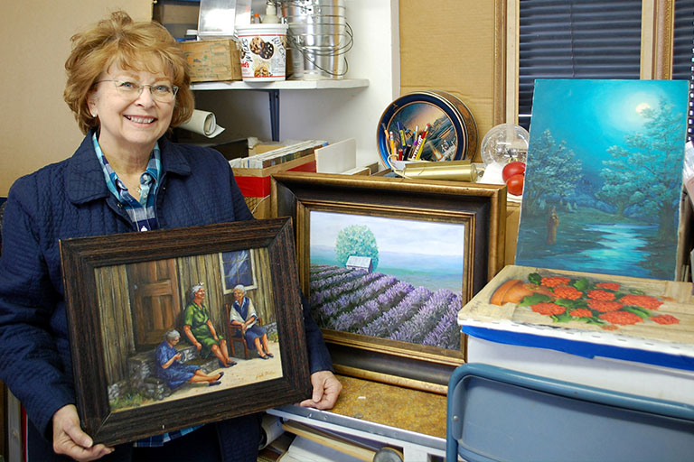 Gayle Walker with her paintings. 