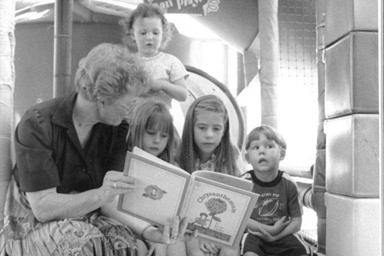 Melveta Walker, director of the Golden Library, reading to children. 