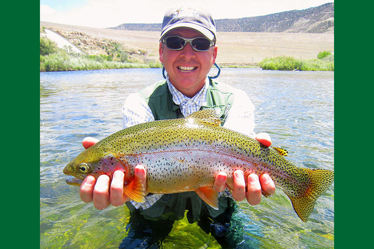 Dr. Jason Paulk, director of Choral Activities at ENMU, with San Juan River rainbow trout.