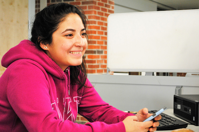 Student smiling in the library