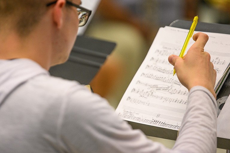 student reading music sheet