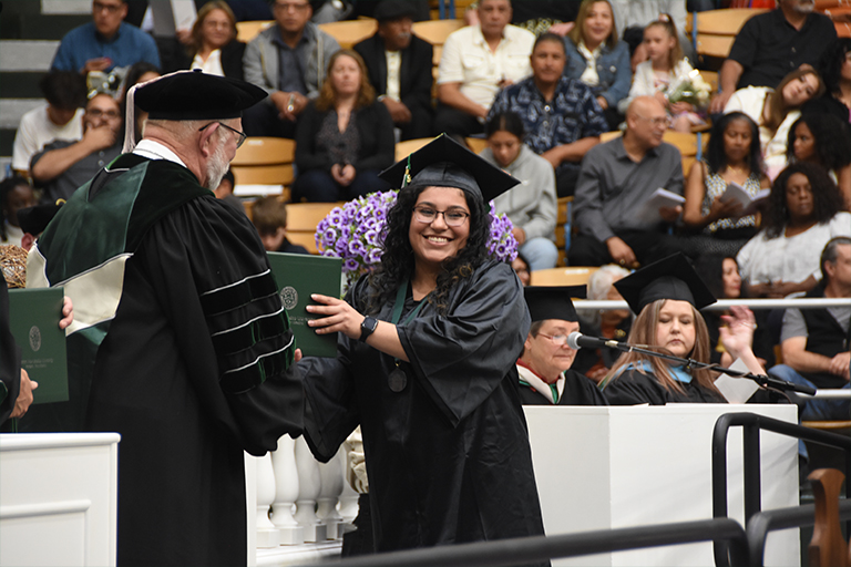 student receiving diploma