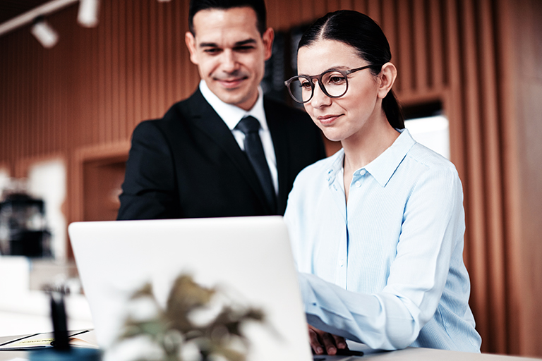 Man and woman looking at laptop