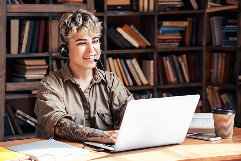 Woman wearing headset while typing at the computer