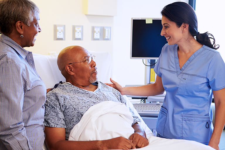 Nurse speaking with patient and family