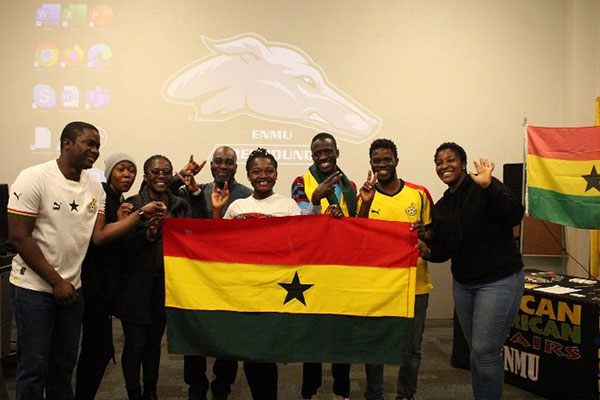 People at AAA Conference holding AAA flag