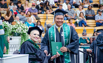 Board of Regents President Ruiz presenting a degree to a student at the past commencement ceremony. 