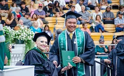 Board of Regents President Ruiz presenting a degree to a student at the past commencement ceremony. 
